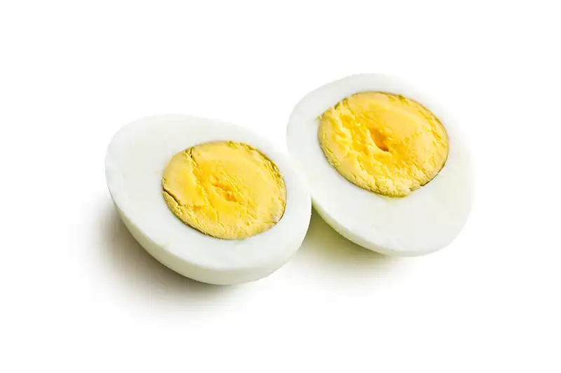 two halves of a boiled egg on white background